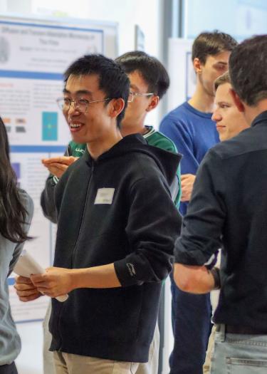 Researchers discussing results at a poster